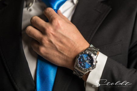 Business photography of a businessman in a suit and with a tie wearing a wrist watch