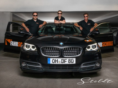 Business photography driving school teachers posing with a car