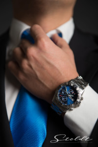 Business photography of a hand of a businessman in a suit and with a tie wearing a wrist watch