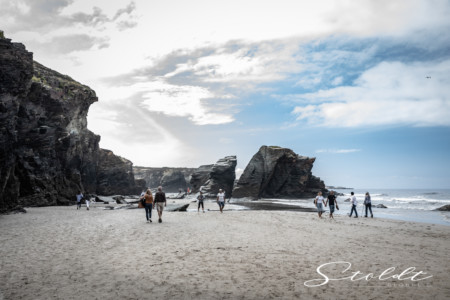 Nature and landscape photography people having a walk at the beach in Spain