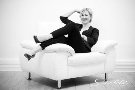 Portrait shooting of a business woman sitting in a chair